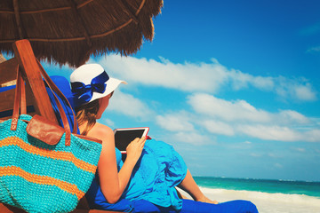 Wall Mural - woman with touch pad on tropical beach