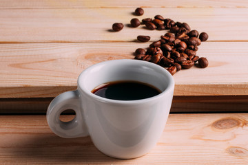 Cup of Coffee with Spilled Coffee Beans