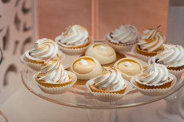 Wall Mural - glass stand with cupcakes on a wedding candy bar table