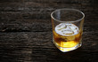 © kathayut - whiskey with ice cubes served on Old wood table