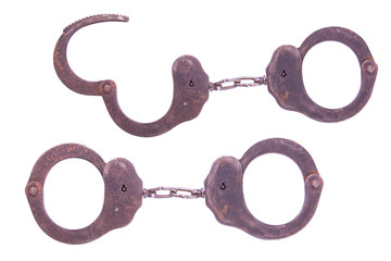 Old rusty handcuffs isolated on white background