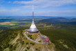 Aerial view of Jested tower on the top of Jested mountain 1 012 m (3,320 ft). Famous tourist attraction near Liberec in Czech republic, Europe. TV broadcast tower was built between 1963 and 1968.