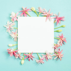 bunch of little lovely flower on white empty paper card over blue background for making card in mother's day, wedding invitation, anniversary or fill word in special occasionally