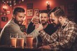 © Nejron Photo - Cheerful old friends having arm wrestling challenge in a pub.