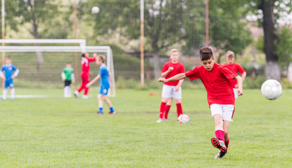 Kids soccer football - children players match on soccer field