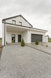 Front of modern house with gravel driveway