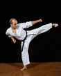 © andreyfire - A kick  leg to the side athlete beats in karategi Kaderov