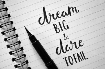 DREAM BIG & DARE TO FAIL motivational quote written in notebook