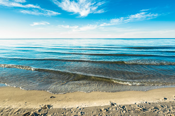 Sand beach and blue sky over the summer azure sea, landscape