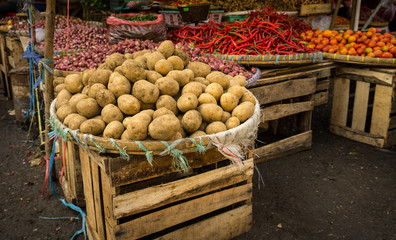 Potatoes stacked on top of bamboo webbing and wood box photo taken in Bogor traditional market