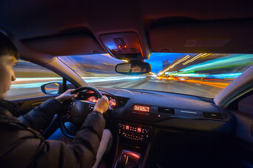 Wall Mural - City road view from inside car natural light street and other cars is motion blurred