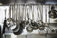 Utensils On Metal Rack In Commercial Kitchen