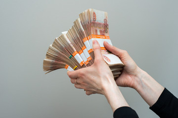 Hand with russian roubles bills  on white background