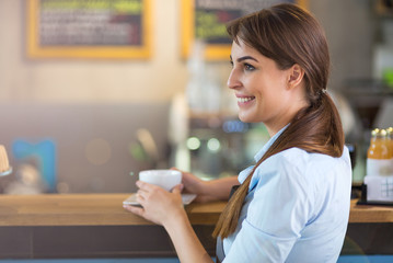 Wall Mural - Woman working in coffee shop
