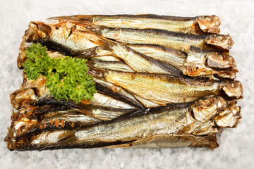 Wall Mural - smoked sprats and parsley on white paper