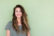 © mimagephotos - smiling young woman against green background