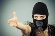 © Voyagerix - Woman in balaclava gun gesture, crime and violence