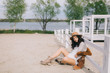 © anatoliycherkas - Beautiful model in hat and dress in hippie style posing on summer beach.