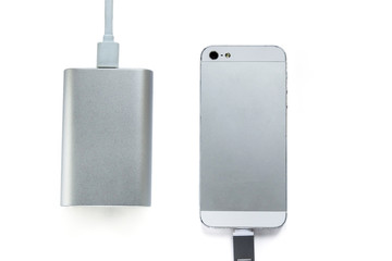 Smartphone charging with portable external battery ( power bank ) isolated on a white background