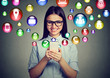 © pathdoc - woman using smartphone with application symbols icons flying out of screen