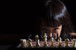 Leinwandbild Motiv Asian Little Chinese girl playing chess
