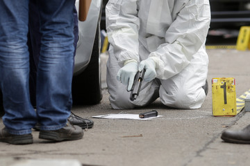 Crime scene/ Criminal investigators / BUCHAREST, ROMANIA - MAY 10: criminal investigators are inspecting a  handung on a crime scene on May 10, 2017, in Bucharest.