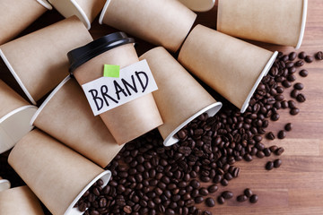 Wall Mural - coffee identity brand building concept with coffee beans and lots of paper coffee cups background