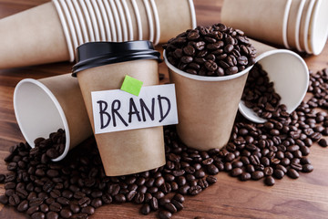 Wall Mural - coffee identity brand building concept with coffee beans and lots of paper coffee cups background