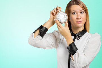 Wall Mural - Portrait of young woman holding alarm watch