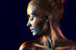 © Africa Studio - Portrait of beautiful young woman with dark paint and sparkles on her body, dark background