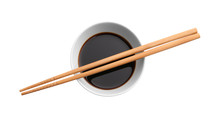 Bowl With Tasty Soy Sauce And Chopsticks On White Background