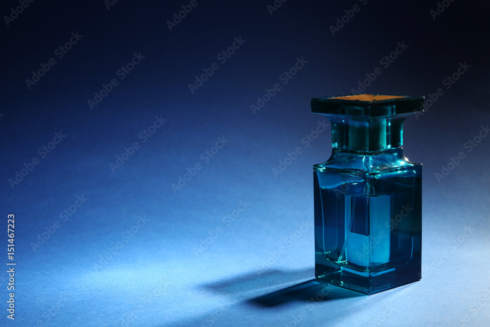 Bottle of modern male perfume on color background