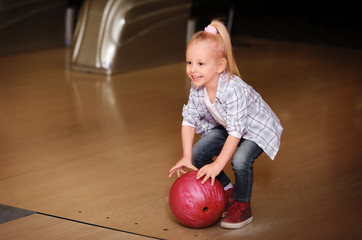 Wall Mural - Cute child with ball in bowling club