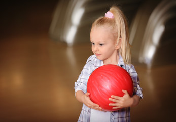 Poster - Cute child with ball in bowling club