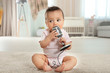 © Africa Studio - Cute little baby with microphone at home