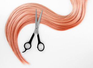 Wall Mural - Long blond hair and scissors isolated on white