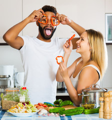 Interracial couple cooking vegetables