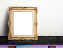 Blank Gold Victorian Picture Frame On Black Marble Table At Grey Concrete Wall,Template Mock Up For Adding Your Design And Leave Space Beside Frame For Adding More Text.