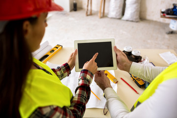 Wall Mural - Engineers with tablet at construction site