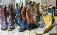 A Group Of Nine Pairs Of Old Cowboy Boots