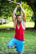 © theartofphoto - Tattooed sportsman with beard looking away in sunlight outdoor. Cloudy sky on background