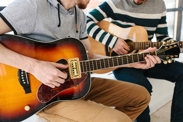 Wall Mural - Learning to play the guitar. Music education.