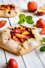 Wall Mural - Traditional French Galette pie filled with strawberry and peach