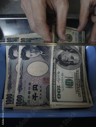 Money Changer Places Some One Hundred U S Dollar Bills Next To Money Changer Places Some One Hundred U S Dollar Bills Next To Anese Yens At An Exchange Booth In Tokyo