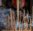 Smoke arising from burning incense sticks at a buddhist temple