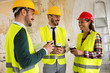 © didesign - Group of architects talking on coffee break at construction site