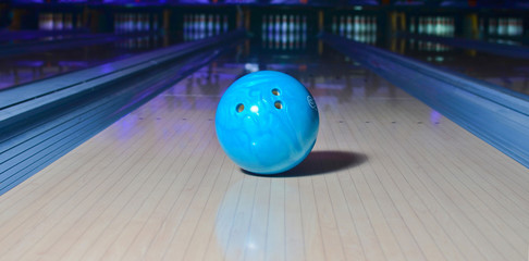 Blue bowling ball on the track. Active leisure. Sport game.