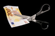 © Serge Aubert - Scissors cut banknote, devaluation and tax concept. Isolated on black background. With copy space text. Studio Shot.