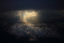 Rays Of Light Shining Through Dark Clouds On Another Cloud Layer For Background