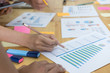 © 88studio - startup young successful team on meeting in modern office interior brainstorming, make a business plan, working on tablet with financial and marketing graph and chart
